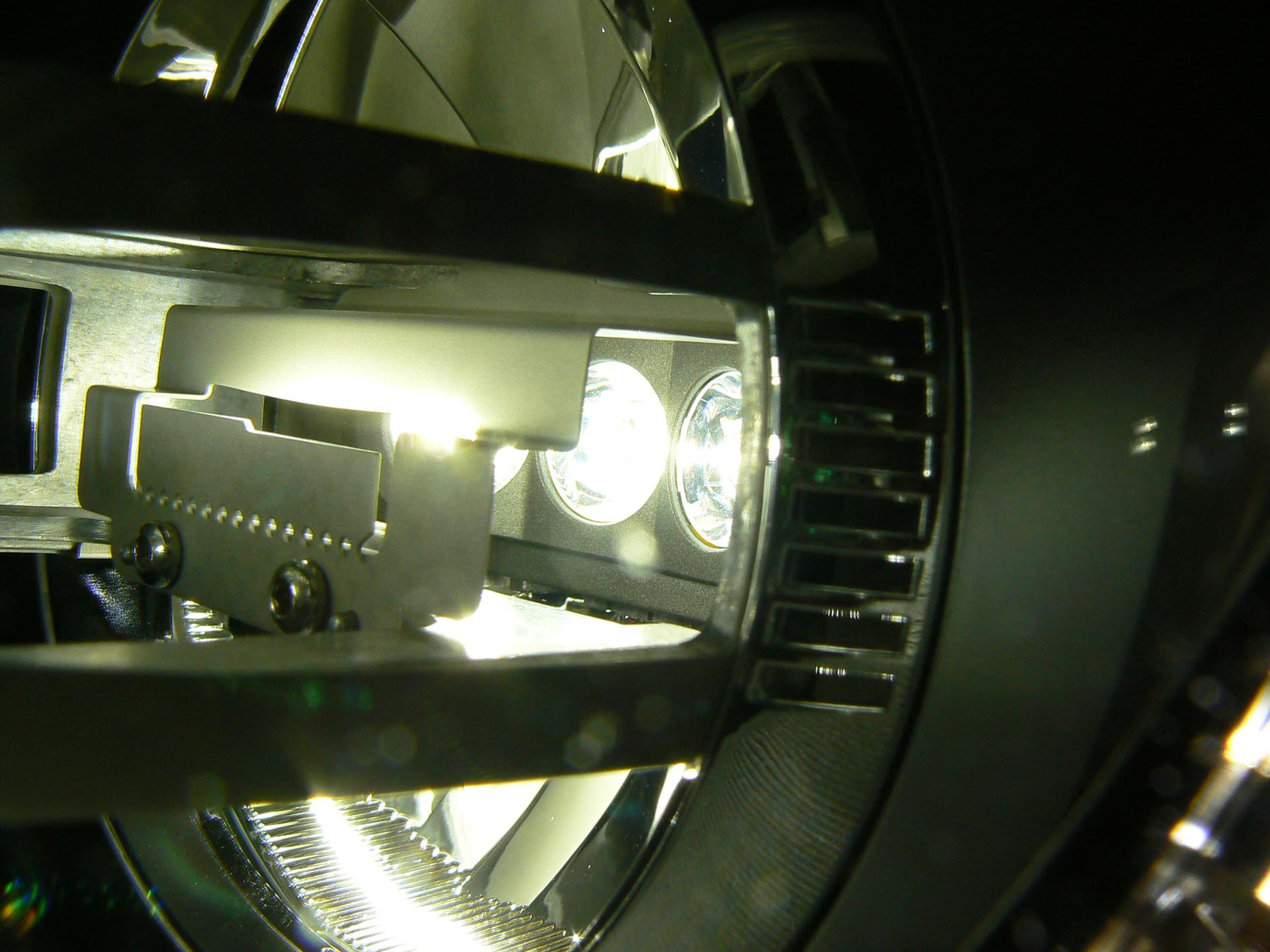 LED lighting technology is relatively expensive up front, and can be sensitive to high-temperature environments. Without very careful heat-sinking, LED lighting systems can suffer damage if used in an area with a high ambient temperature. Here is a close-up of an early LED headlight system, in a 2011 Audi R8.