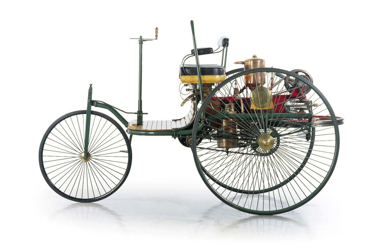 While there were other contraptions that could claim to be the first car, Karl Benz's invention was the first automobile in that it was designed from the ground up to be powered by an engine. The three-wheeled motorwagen boasted tiller steering, wagon-style wheels, and a single-cylinder four-stroke engine that produced anywhere from two-thirds of a horsepower to nine-tenths of a horsepower. The burnout was clearly yet to be invented. Benz's wife Bertha is often overlooked in the story of the automobile, but she was the first to travel any distance in her husband's invention (which her money had backed), as well as coming up with brake linings and fuel stops along the way. The automobile was here, and the first road trip had happened almost immediately.
