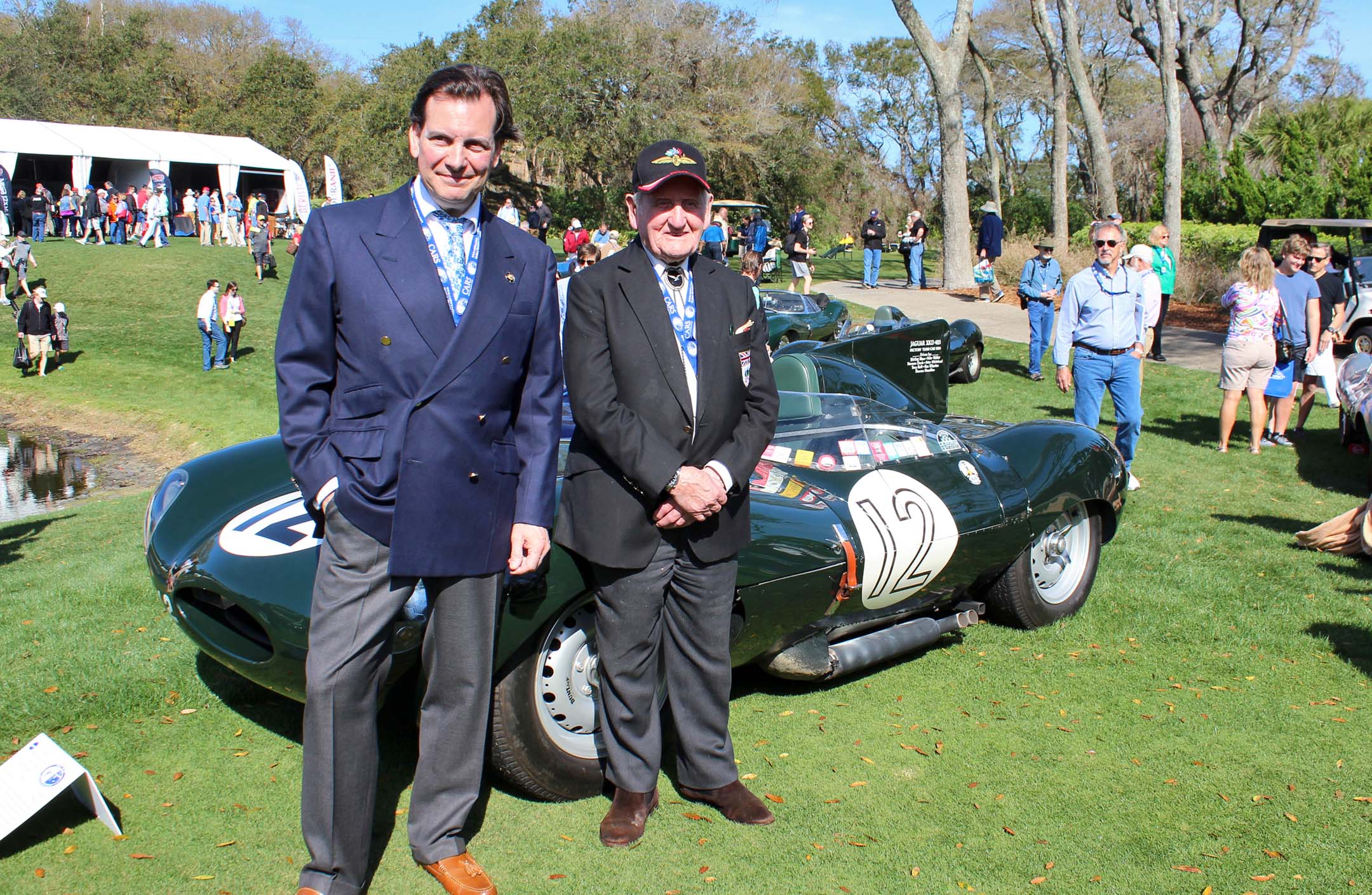 Michael Quinn (grandson of Jaguar founder Sir William Lyons) and Norman Dewis, Jaguar development driver in front of 1955 D-Type