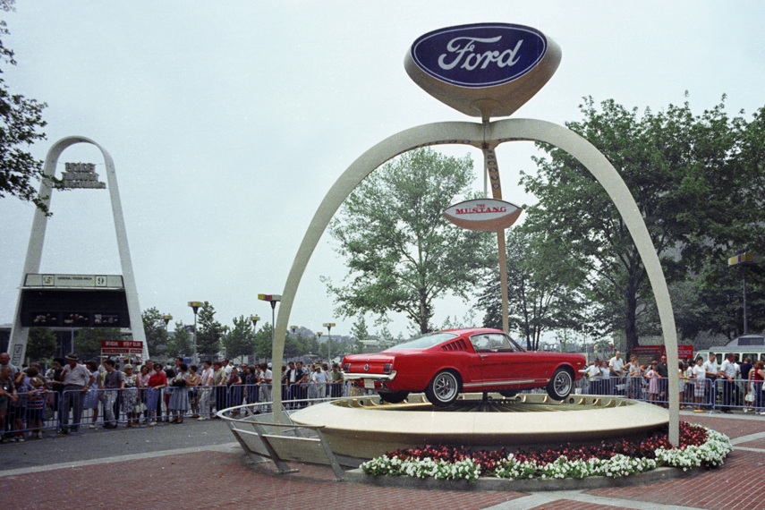 1965 Ford Mustang fastback in front the Ford Pavilion at the 1964 World's Fair in New York.
