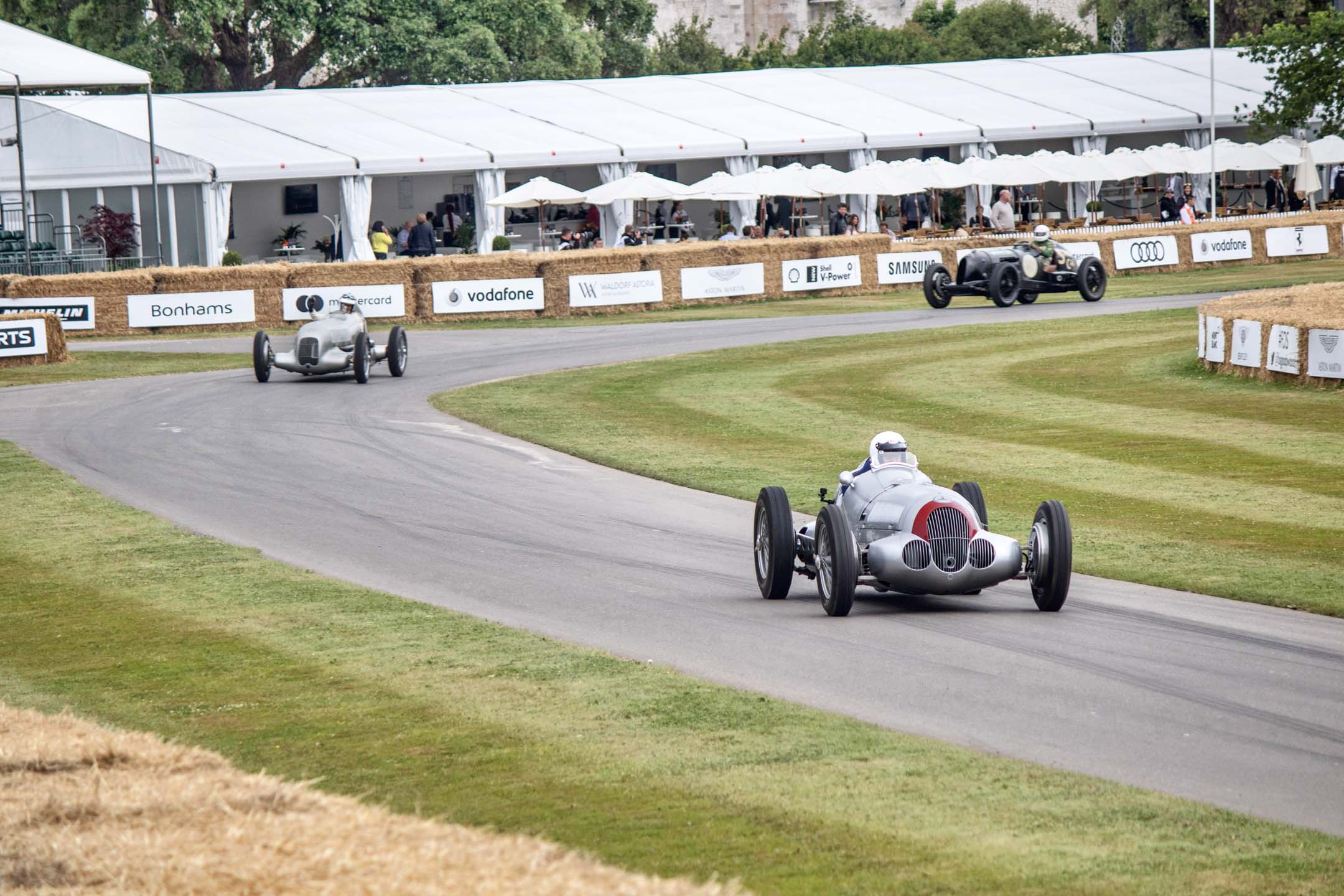 The Silver Arrows lead the pack down to the staging area. Astoundingly loud, complete with whining superchargers, this pair of vintage racers sounded like the grumpy ancestors of the Dodge Hellcat. The Mercedes Silver Arrows racing team dominated everyone, much like today’s F1 team.