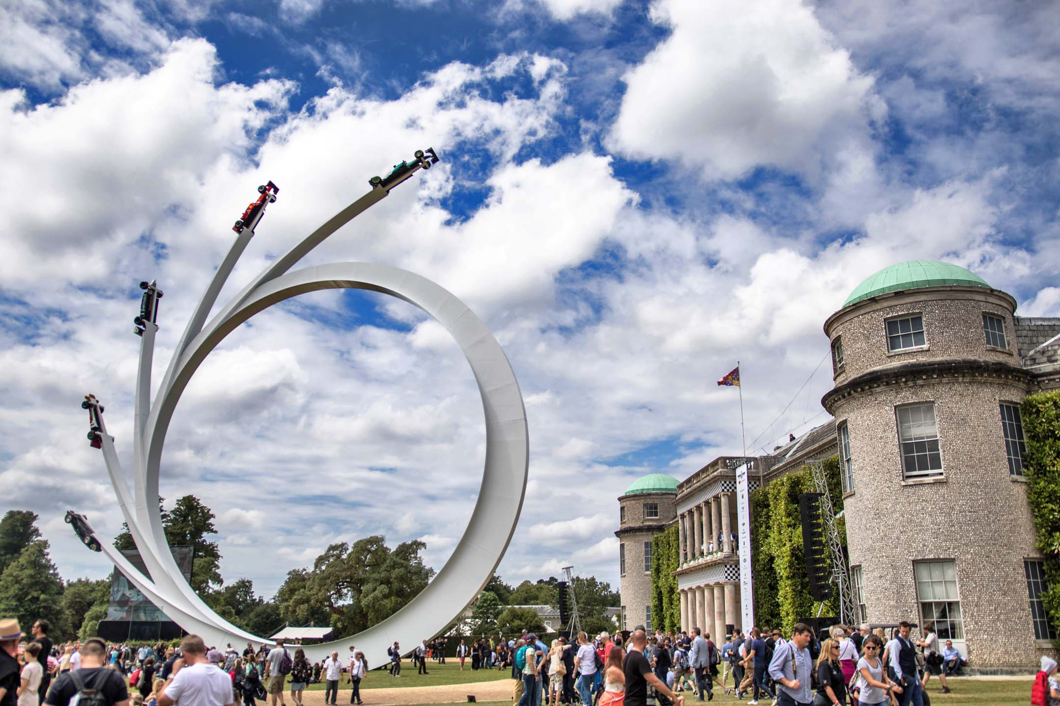 Towering into the sky outside Goodwood’s stately living quarters, a quintet of F1 racing machines arc into the sky. The feature is erected each year, and new cars fixed onto it, depending on the theme of the show.